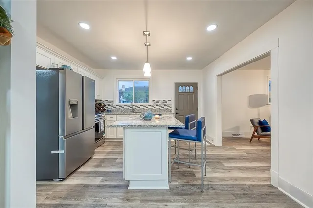 a bathroom with a granite countertop sink mirror and shower