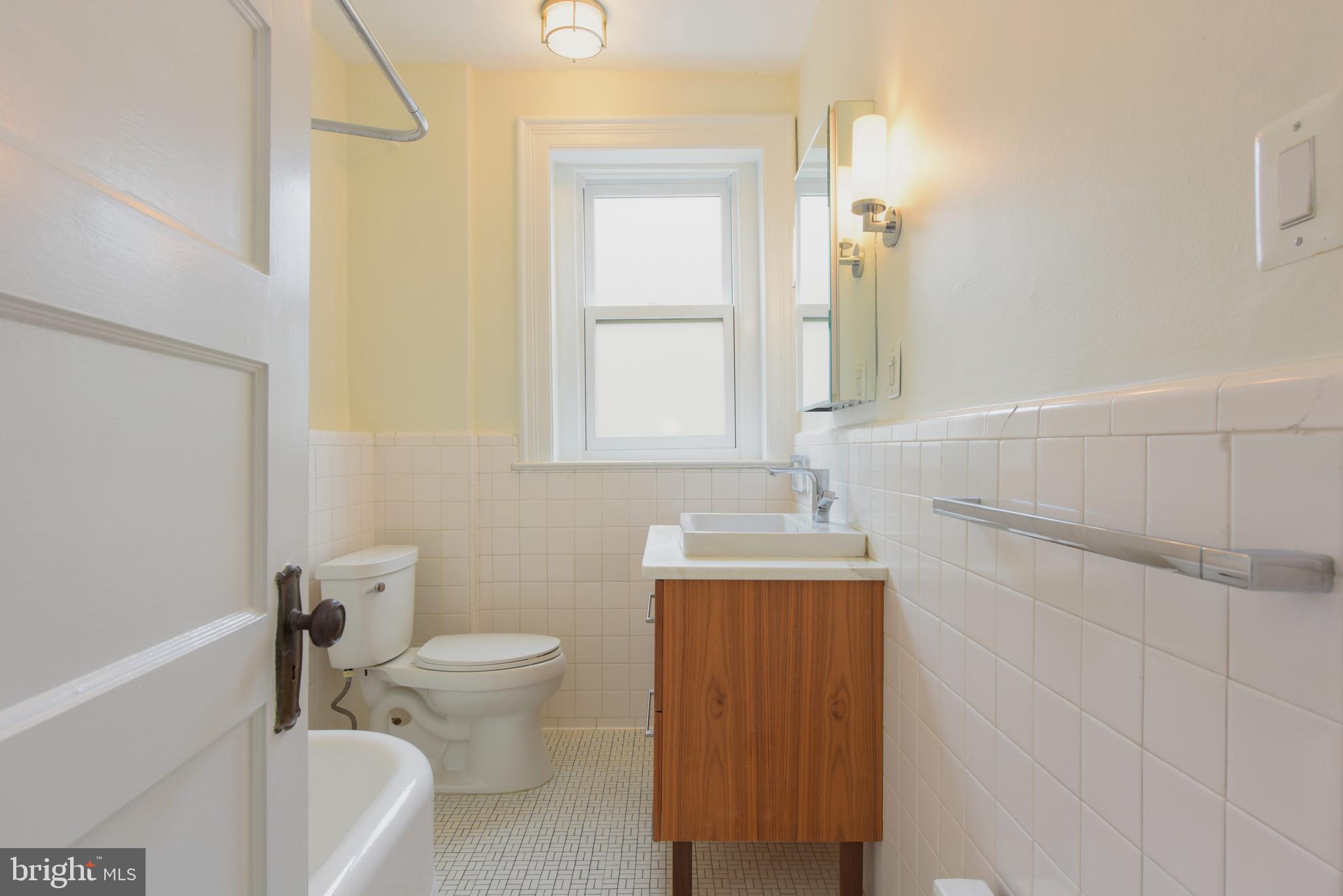 2022 Columbia Road Northwest, Unit 612 Washington, DC 20009 - Photo 14 of 29 a bathroom with a sink a toilet and shower