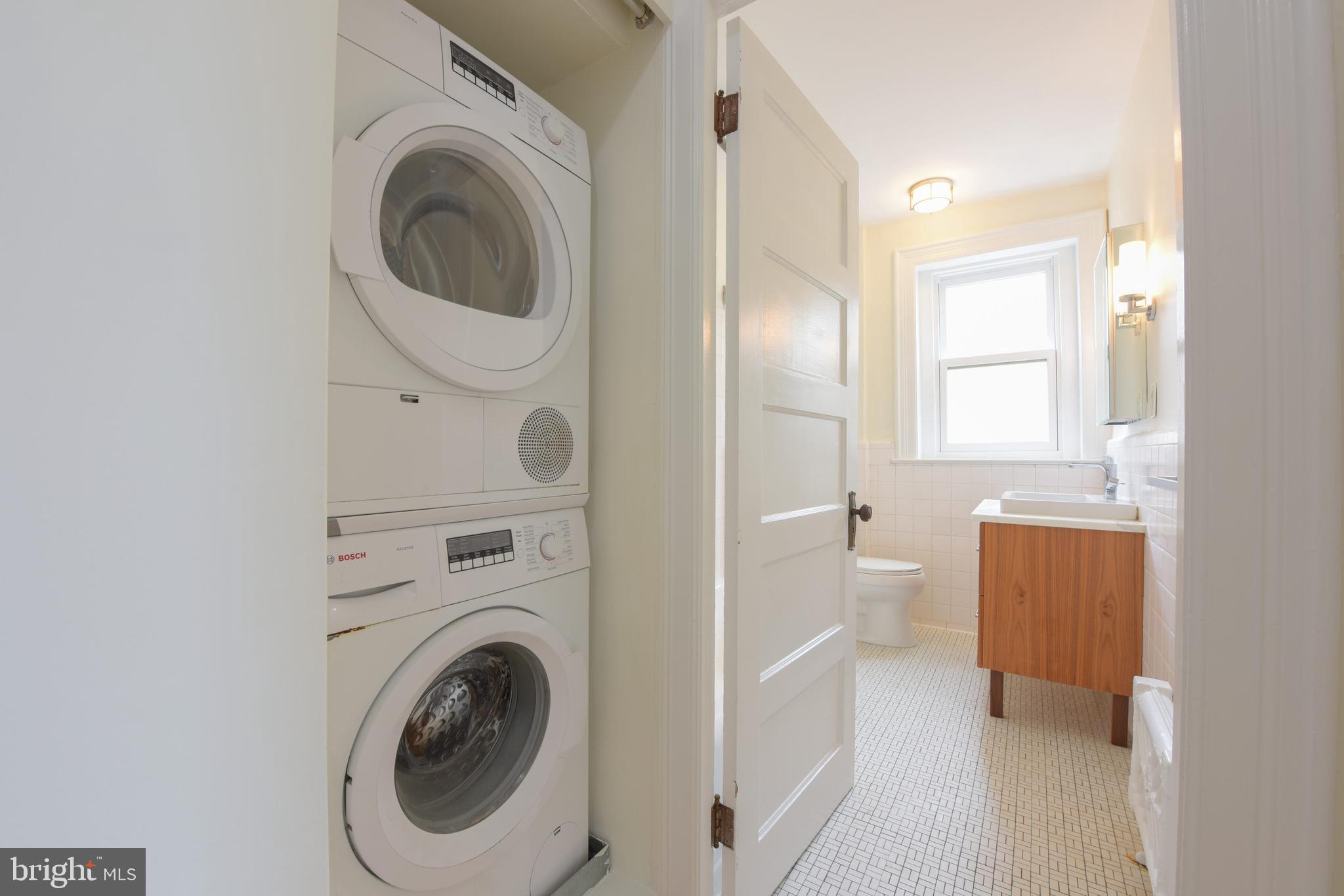 2022 Columbia Road Northwest, Unit 612 Washington, DC 20009 - Photo 16 of 29 a view of a hallway with washer and dryer