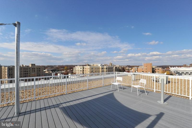 2022 Columbia Road Northwest, Unit 612 Washington, DC 20009 - Photo 23 of 29 a view of a balcony with wooden floor and city view