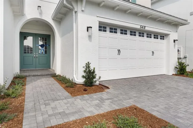 a view of front door and a potted plant