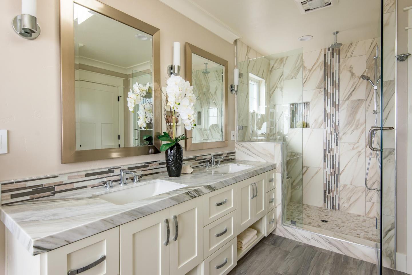 10416 Prune Tree Lane Cupertino, CA 95014 - Photo 12 of 21 a bathroom with a granite countertop double vanity sink mirror and shower