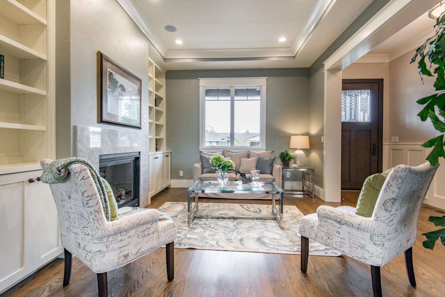10416 Prune Tree Lane Cupertino, CA 95014 - Photo 3 of 21 a living room with furniture fireplace and a table