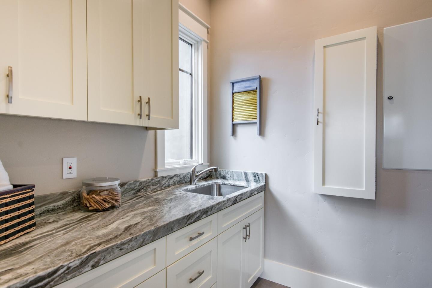 10416 Prune Tree Lane Cupertino, CA 95014 - Photo 9 of 21 a kitchen with granite countertop white cabinets and sink