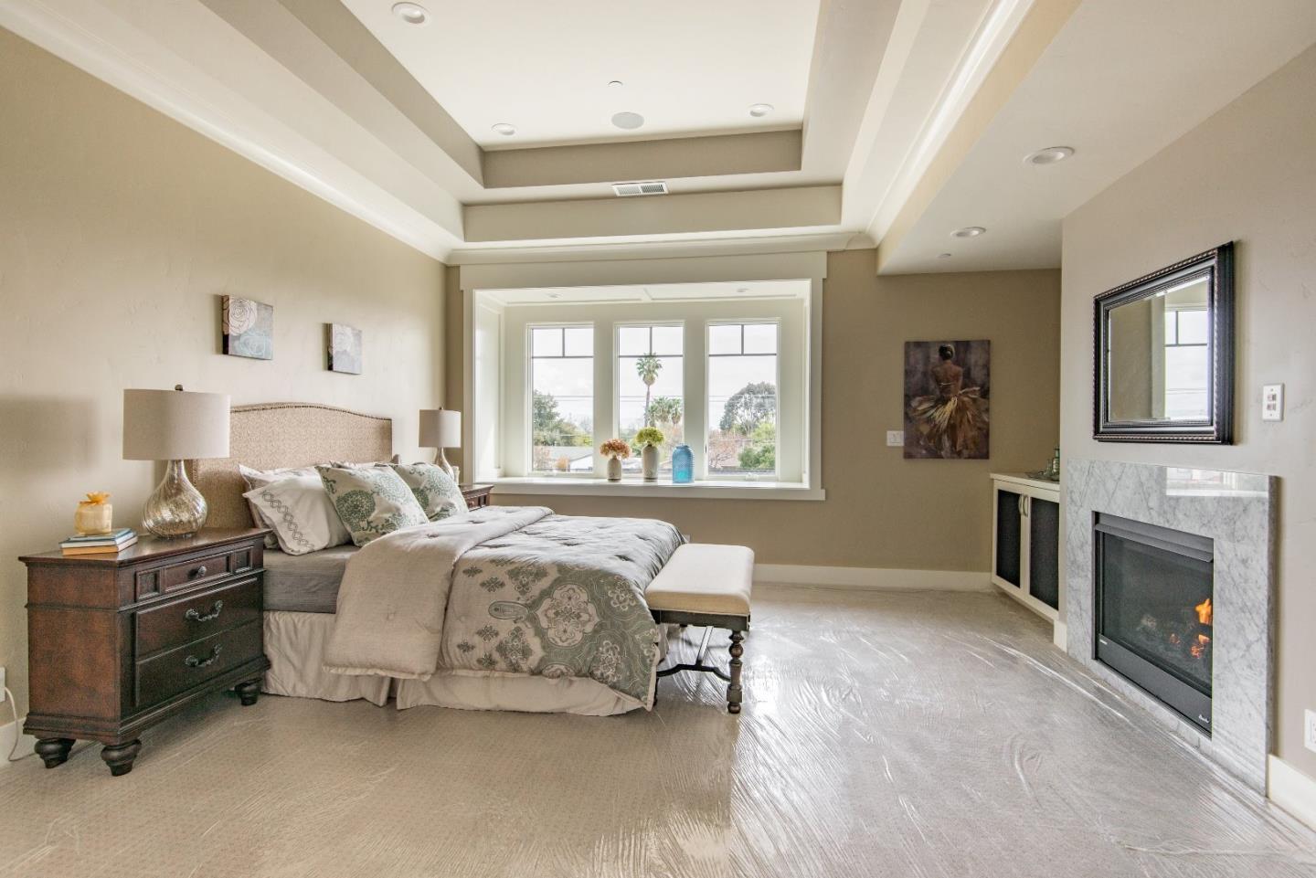 10416 Prune Tree Lane Cupertino, CA 95014 - Photo 10 of 21 a spacious bedroom with a bed and a fireplace