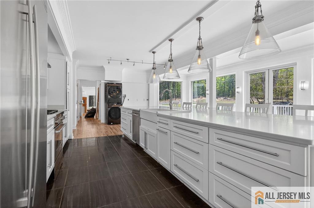 381 Monmouth Road Freehold, NJ 07728 - Photo 17 of 63 a large kitchen with granite countertop a large counter top appliances and cabinets