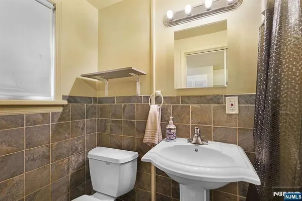 a bathroom with a sink toilet and mirror