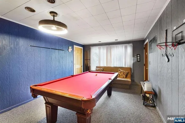 a room with pool table and windows