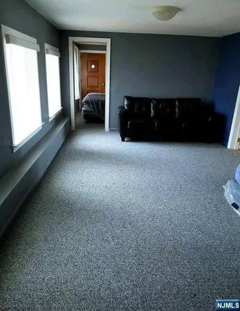 a view of a livingroom with furniture and fan