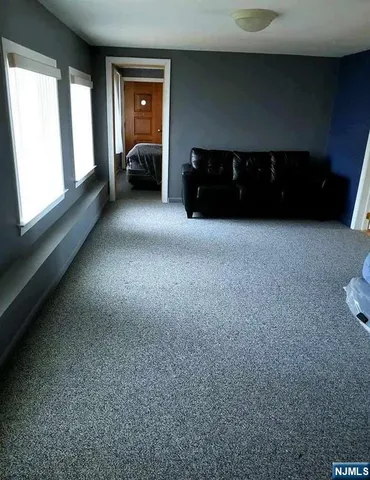 a view of a livingroom with furniture and fan