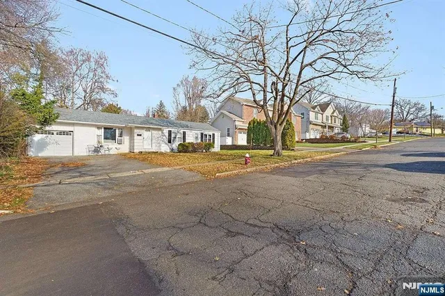 a view of road with large trees
