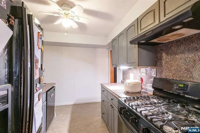 a kitchen with stainless steel appliances granite countertop a stove and a refrigerator