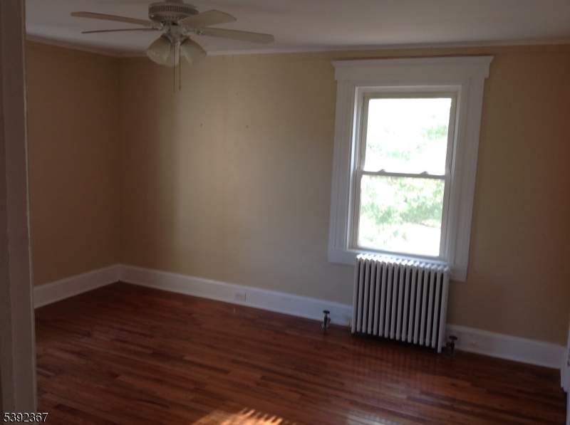 49 Wertsville Road, Unit C Hillsborough, NJ 08844 - Photo 17 of 19 an empty room with wooden floor closet and windows