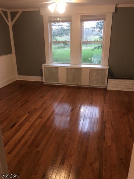 49 Wertsville Road, Unit C Hillsborough, NJ 08844 - Photo 2 of 19 an empty room with wooden floor and windows
