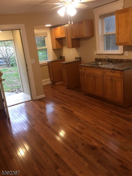 49 Wertsville Road, Unit C Hillsborough, NJ 08844 - Photo 7 of 19 a kitchen with stainless steel appliances granite countertop a sink stove and wooden floor