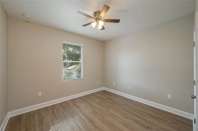 wooden floor in an empty room with a window