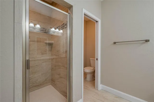 a bathroom that has a glass shower door
