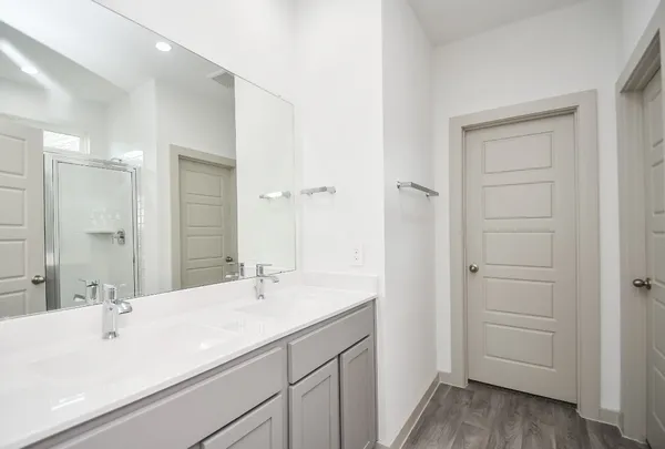 a bathroom with a double vanity sink and mirror