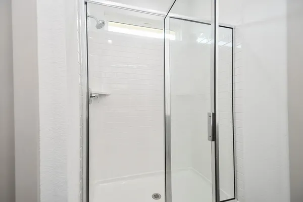 a bathroom with a glass shower door