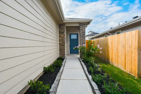 a front view of a house with plants