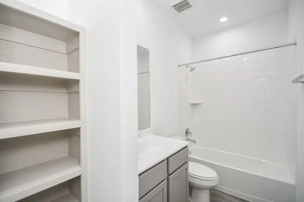 a bathroom with a toilet a sink and a bathtub