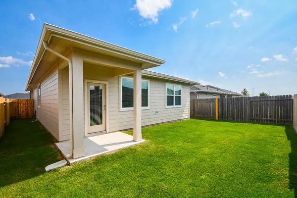 a view of a house with backyard and porch