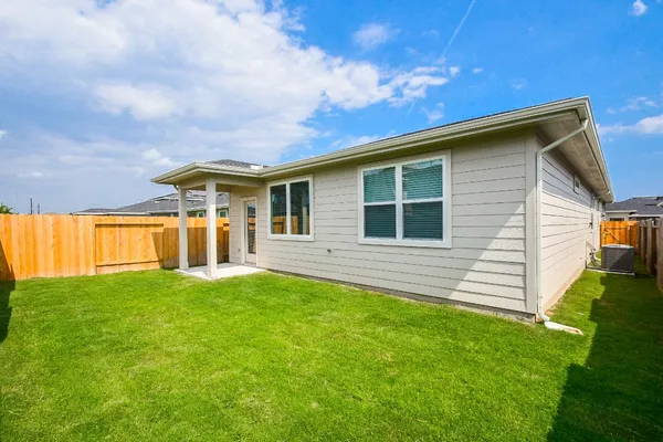 a view of a house with a backyard