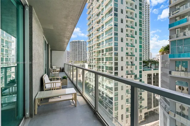 a view of a balcony with couches and pool view