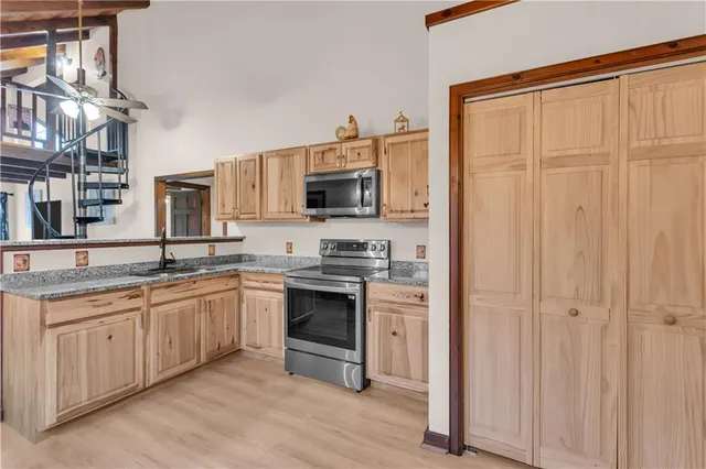 a very nice looking room with a large window and furniture