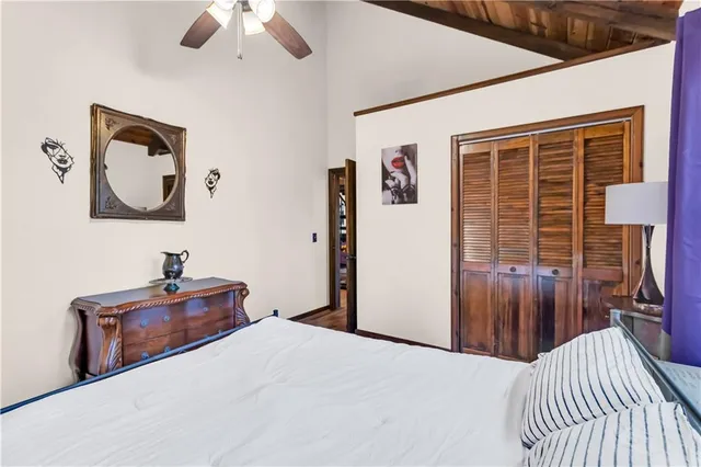 a bed sitting in a bedroom next to a large window