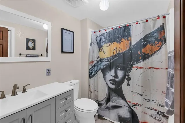 a bedroom with a bed a flat screen tv and chandelier