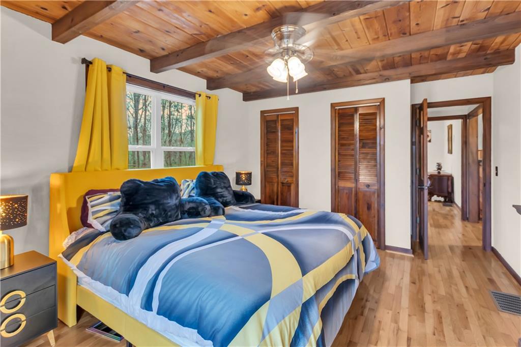 112 Old Stagecoach Road Clarkesville, GA 30523 - Photo 27 of 39 a bed sitting in a bedroom next to a window