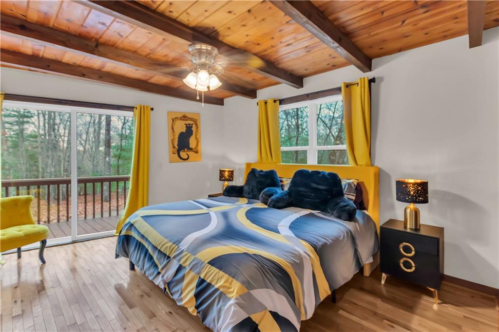 112 Old Stagecoach Road Clarkesville, GA 30523 - Photo 28 of 39 a bed sitting in a bedroom next to a large window