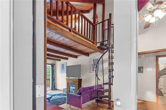 a view of a lush green forest with mountains in the background