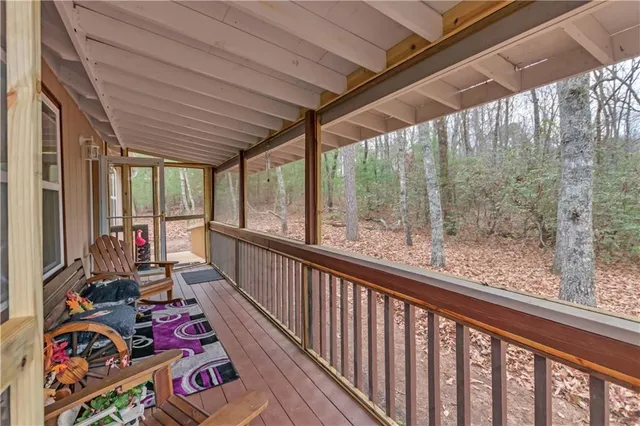 a view of a porch with wooden floor and outdoor seating