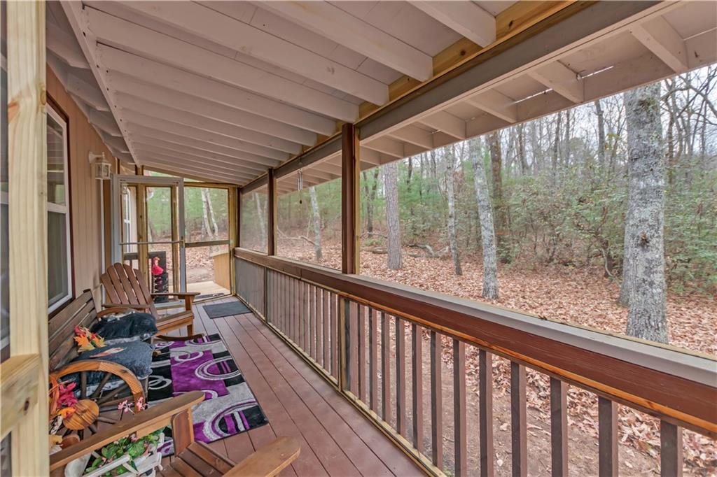 112 Old Stagecoach Road Clarkesville, GA 30523 - Photo 8 of 39 a view of a porch with wooden floor and outdoor seating