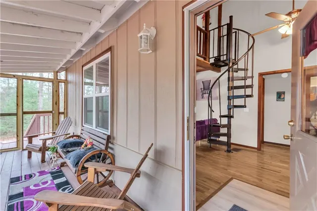 a view of a livingroom with furniture and floor to ceiling window
