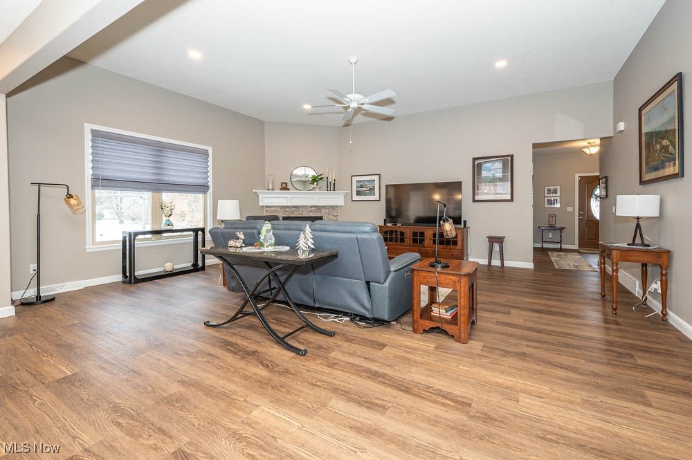 6580 Abbey Road North Canfield, OH 44406 - Photo 9 of 32 Living area with a stone fireplace, ceiling fan, and wood finished floors