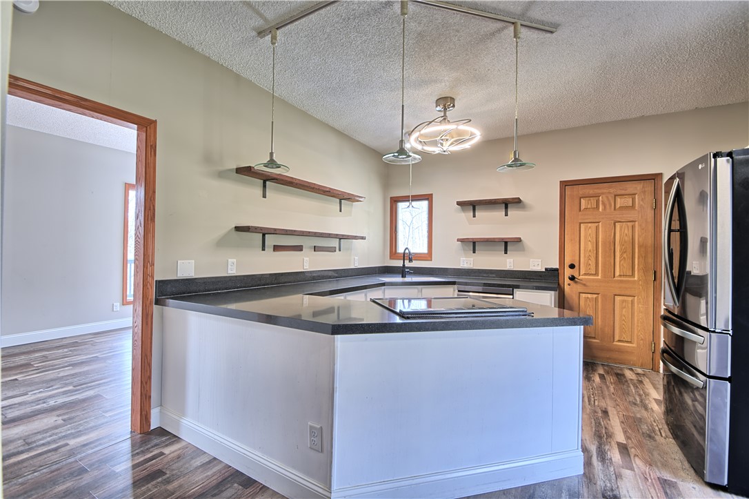8711 Nicole Lane Springboro, OH 45066 - Photo 10 of 87 This kitchen features sleek countertops, modern appliances, and convenient open shelving.