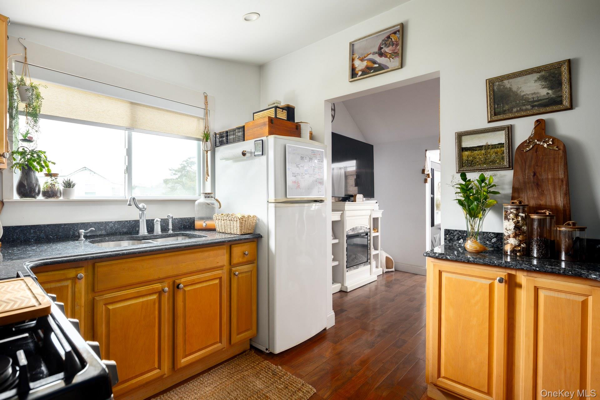 24 Blue Point Road Mastic Beach, NY 11951 - Photo 11 of 16 a kitchen with a refrigerator and a sink