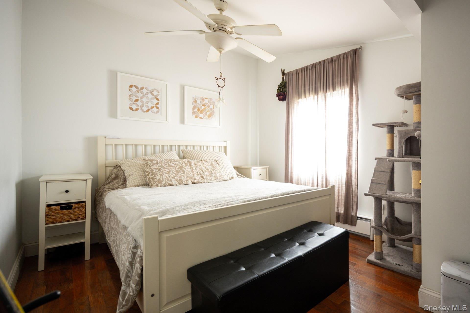 24 Blue Point Road Mastic Beach, NY 11951 - Photo 13 of 16 a bedroom with a bed and a tv