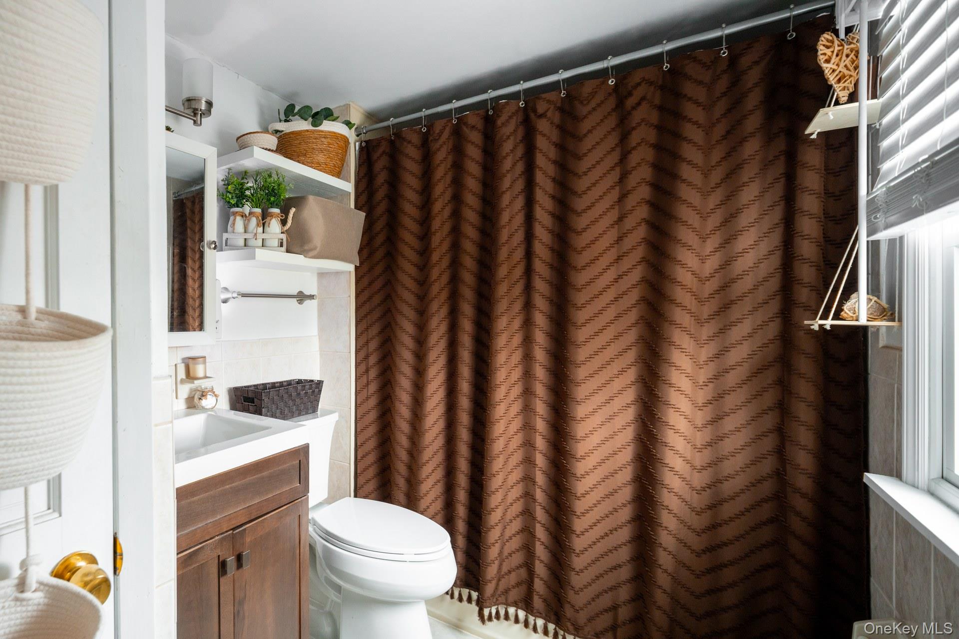 24 Blue Point Road Mastic Beach, NY 11951 - Photo 15 of 16 a bathroom with a sink toilet and shower