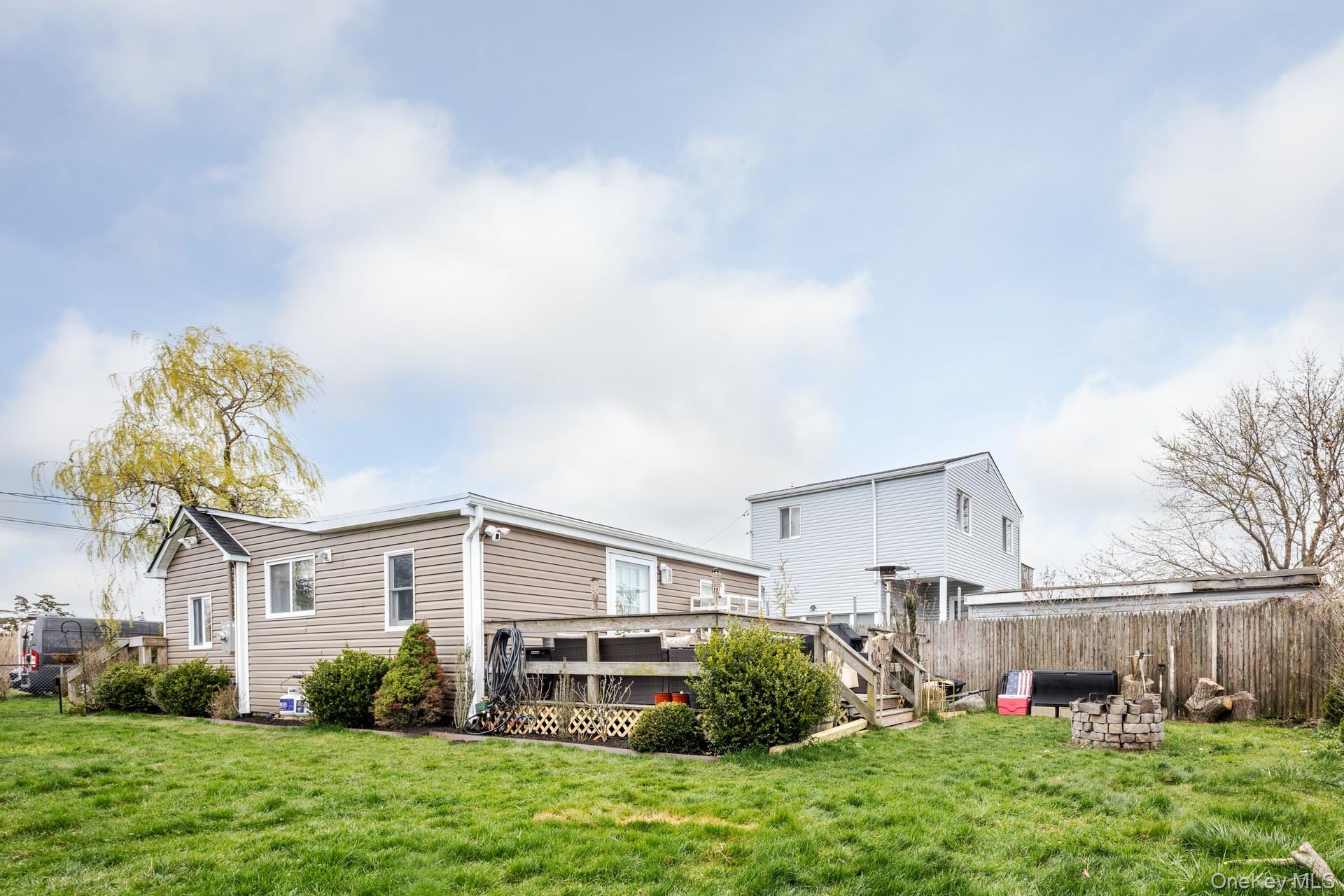 24 Blue Point Road Mastic Beach, NY 11951 - Photo 2 of 16 a front view of a house with a yard and potted plants