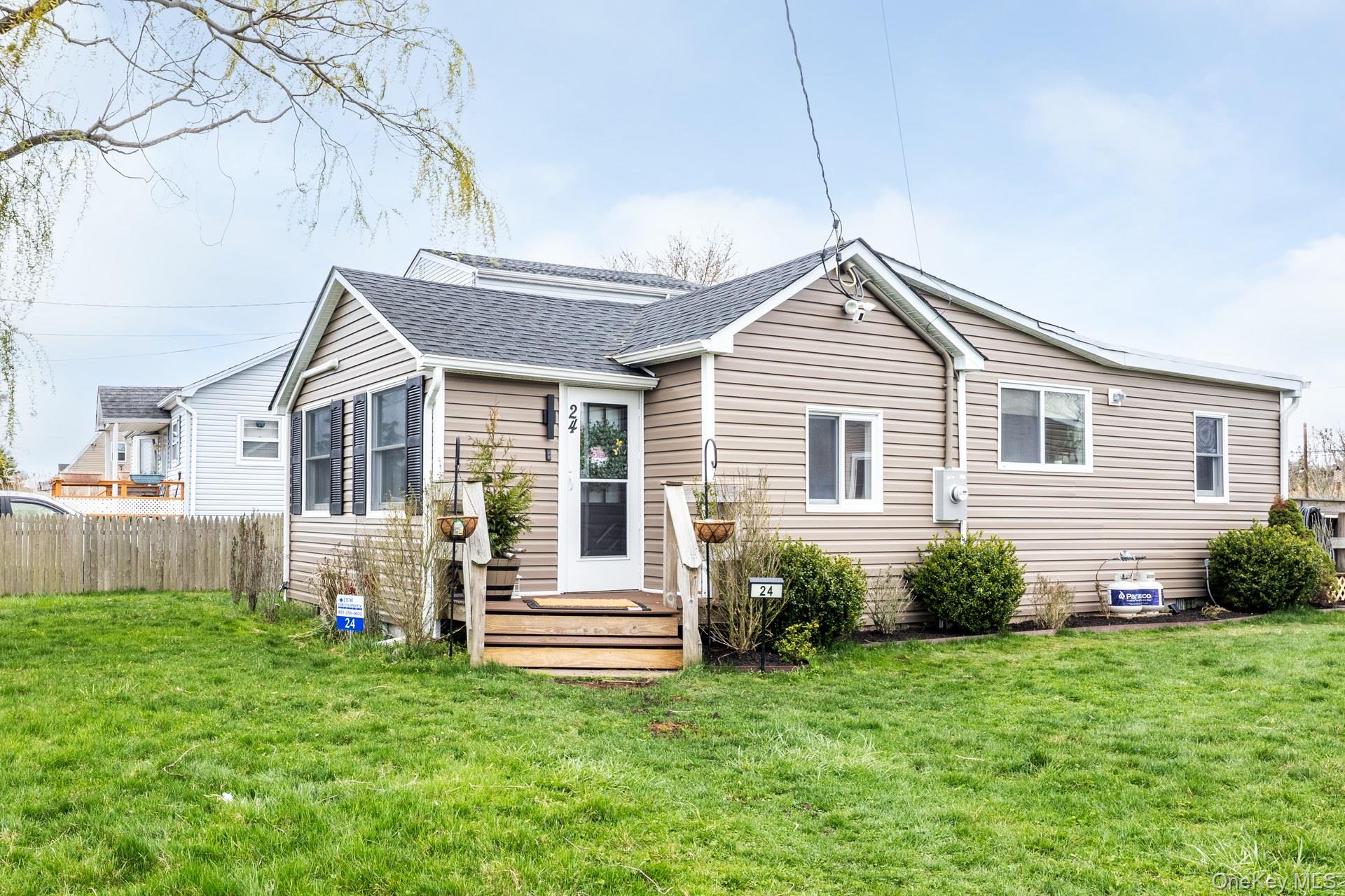 24 Blue Point Road Mastic Beach, NY 11951 - Photo 6 of 16 a house view with a garden space