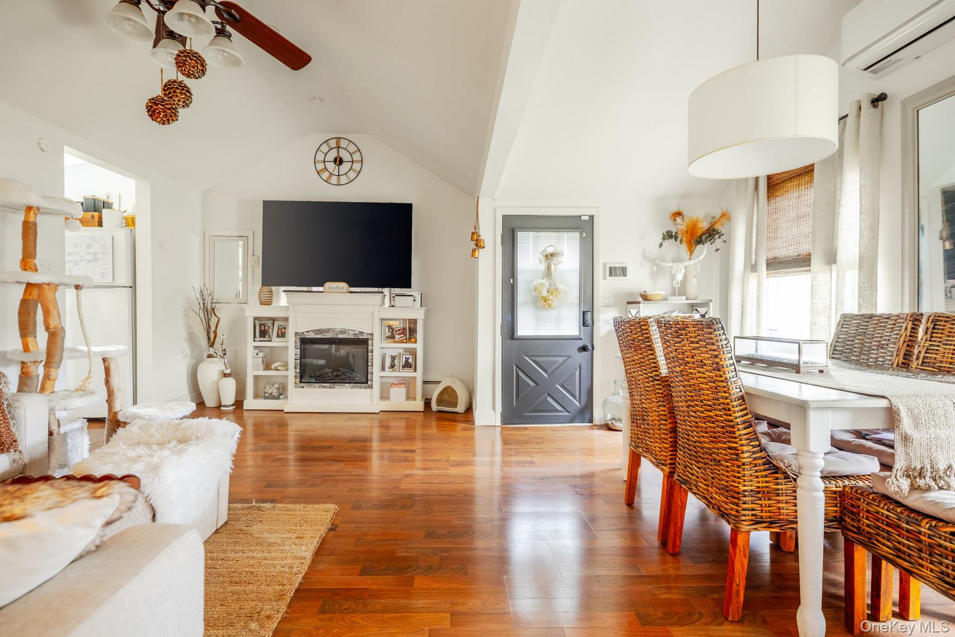 24 Blue Point Road Mastic Beach, NY 11951 - Photo 7 of 16 a living room with furniture a flat screen tv and wooden floor