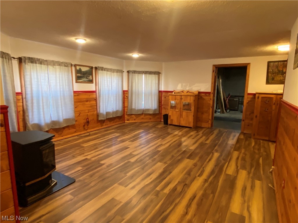 2008 Goose Creek Road Petroleum, WV 26161 - Photo 13 of 35 Unfurnished living room featuring a wood stove and dark hardwood / wood-style flooring