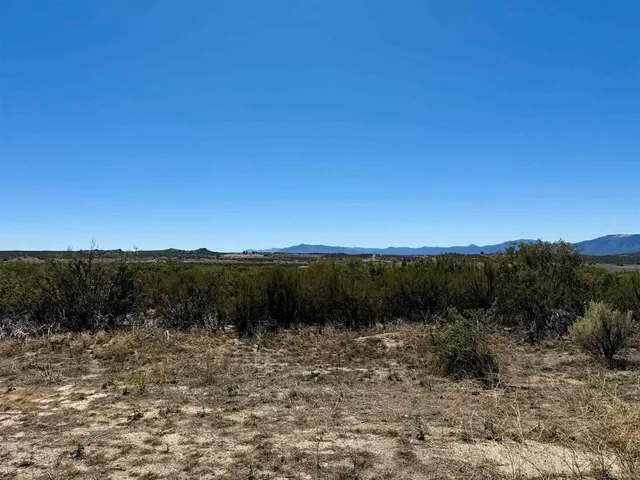 a view of a lake and green valley