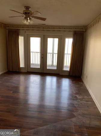 a view of a livingroom with wooden floor and a window