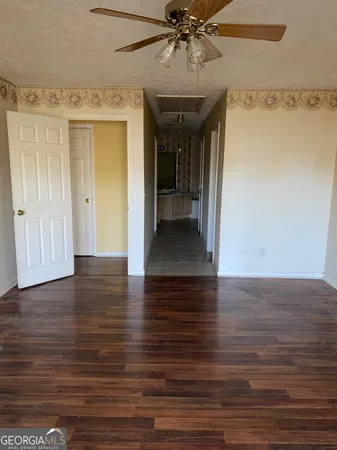 a view of a hallway with wooden floor and closet