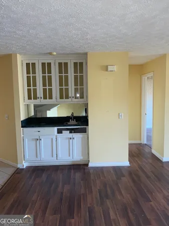 a view of a kitchen with wooden floor and a sink